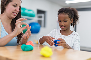 women playing with toys with a little girl 