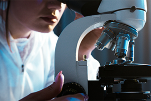 picture of student looking at a microscope