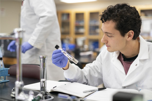 student holding test tube