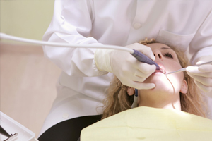 women getting her teeth checked 