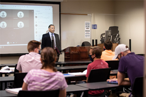 professor teaching class in a classroom 