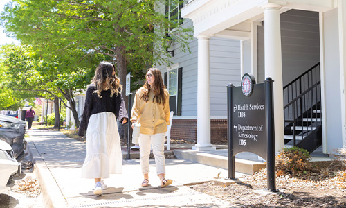 two college students walking on campus